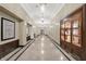 Long hallway with marble flooring, decorative lighting, and elegant displays, leading to various suites at 350 N Meridian N St # 701, Indianapolis, IN 46204