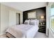 Modern bedroom with a dark accent wall, comfortable bed, and ample natural light from the window at 3730 Cantebury Dr, Franklin, IN 46131