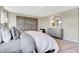 Neutral bedroom featuring a textured accent wall and a round mirror over the dresser at 3730 Cantebury Dr, Franklin, IN 46131