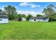 Large backyard with lush green grass, a storage shed, and a view of the home at 374 S Baldwin St, Bargersville, IN 46106
