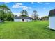 Lush backyard with well-maintained lawn, patio, blue house, and storage shed at 374 S Baldwin St, Bargersville, IN 46106