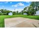 A concrete patio in a large, well-manicured backyard offers the perfect outdoor entertaining space at 374 S Baldwin St, Bargersville, IN 46106