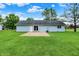 Back of house and patio overlooking a large well-maintained backyard with lush lawn at 374 S Baldwin St, Bargersville, IN 46106