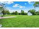 Expansive backyard features a storage shed, patio, and lush green lawn for activities at 374 S Baldwin St, Bargersville, IN 46106