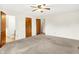 A spacious bedroom with neutral carpet, with multiple doors and a ceiling fan at 374 S Baldwin St, Bargersville, IN 46106