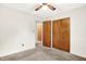 Bedroom with carpeted floor, ceiling fan and wood-paneled closet with a door to another room at 374 S Baldwin St, Bargersville, IN 46106
