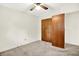 Bedroom with neutral carpet, ceiling fan, and wood paneled closet with an open door at 374 S Baldwin St, Bargersville, IN 46106