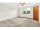 A simple bedroom with neutral carpet, a window, and a ceiling fan at 374 S Baldwin St, Bargersville, IN 46106