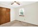 Bedroom with neutral carpet, a ceiling fan, a window with blind and a wood paneled closet at 374 S Baldwin St, Bargersville, IN 46106