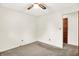 Bedroom features neutral carpet, ceiling fan and doorway with a wood paneled door at 374 S Baldwin St, Bargersville, IN 46106