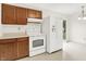 Cozy kitchen with ample cabinet space, a white range, and a full-size refrigerator at 374 S Baldwin St, Bargersville, IN 46106