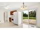Bright kitchen with vinyl flooring, white appliances, wood cabinets, and sliding glass doors to the backyard at 374 S Baldwin St, Bargersville, IN 46106