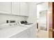 Functional laundry room featuring white cabinets and modern appliances for convenience at 374 S Baldwin St, Bargersville, IN 46106