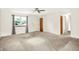 Large, bright living room featuring neutral carpeting, ceiling fan, and large window at 374 S Baldwin St, Bargersville, IN 46106