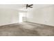 Spacious living area with neutral carpeting, ceiling fan, and an open layout into other rooms at 374 S Baldwin St, Bargersville, IN 46106