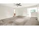 Neutral carpeted living room with ceiling fan, and views into the kitchen and entryway offering seamless transitions at 374 S Baldwin St, Bargersville, IN 46106