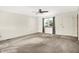 Bright living room with neutral carpet, ceiling fan, a window with natural light, and a white front door at 374 S Baldwin St, Bargersville, IN 46106