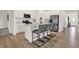 Modern kitchen island featuring counter seating, stainless steel appliances, and attractive laminate flooring at 3778 Cantebury Dr, Franklin, IN 46131