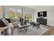 Living room featuring a comfortable couch, coffee table, and large windows with natural light at 3778 Cantebury Dr, Franklin, IN 46131