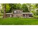 Attractive brick home featuring an inviting patio with seating and a well-manicured lawn at 411 Woodland W Dr, Greenfield, IN 46140