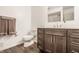 Well-lit bathroom with dark wood vanity, chrome fixtures, and vinyl wood flooring at 411 Woodland W Dr, Greenfield, IN 46140