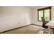 Simple bedroom with a window, carpeted floor, and an office chair at 411 Woodland W Dr, Greenfield, IN 46140