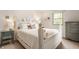 Bright bedroom featuring a decorative white bed frame, neutral walls, and a sunny window at 411 Woodland W Dr, Greenfield, IN 46140