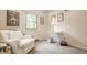 Bright room with natural light featuring a comfortable chair, sewing table, and neutral walls at 411 Woodland W Dr, Greenfield, IN 46140