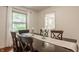 Dining area featuring hardwood floors, natural light, and wooden table at 411 Woodland W Dr, Greenfield, IN 46140