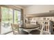 Dining room features a glass-top table with seating for four and sliding door access to the backyard at 411 Woodland W Dr, Greenfield, IN 46140