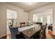 Dining area featuring hardwood floors, wooden table, and natural light at 411 Woodland W Dr, Greenfield, IN 46140