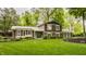 Inviting home with manicured lawn, mature trees, and charming brick accents at 411 Woodland W Dr, Greenfield, IN 46140