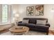 Bright living room showcasing a couch, round wood table, and natural light at 411 Woodland W Dr, Greenfield, IN 46140