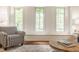 Bright living room showcasing natural lighting, large windows, and patterned armchair at 411 Woodland W Dr, Greenfield, IN 46140