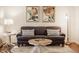 Bright living room featuring a comfortable couch, stylish pillows and artwork at 411 Woodland W Dr, Greenfield, IN 46140