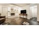 Bright living room with a brick fireplace, dark flooring, and comfortable seating area at 411 Woodland W Dr, Greenfield, IN 46140