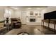 Comfortable living room features a fireplace, neutral decor, and a large television for entertainment at 411 Woodland W Dr, Greenfield, IN 46140