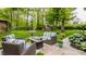 Charming outdoor patio surrounded by lush landscaping with comfortable seating arrangements at 411 Woodland W Dr, Greenfield, IN 46140