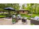 A relaxing outdoor patio featuring an umbrella table and seating, surrounded by a lush green yard at 411 Woodland W Dr, Greenfield, IN 46140