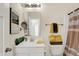 Cozy bathroom with vanity, decorative mirror, and tub-shower combination with patterned curtain at 49 Manchester Dr, Trafalgar, IN 46181