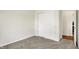 Clean bedroom showcasing carpeted floors and a closet with sliding doors, providing a minimalist space at 49 Manchester Dr, Trafalgar, IN 46181