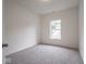 Simple bedroom featuring wall-to-wall carpet, a large window, and neutral decor at 49 Manchester Dr, Trafalgar, IN 46181