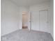Bright bedroom with carpet, a closet with sliding doors, and an adjacent room entrance at 49 Manchester Dr, Trafalgar, IN 46181