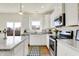Bright kitchen with white cabinets, stainless steel appliances, and a cozy breakfast nook at 49 Manchester Dr, Trafalgar, IN 46181