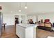 Spacious living room flows into an open kitchen with an island and hardwood flooring at 49 Manchester Dr, Trafalgar, IN 46181