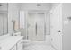 Bathroom with a shower and glass doors, white vanity, toilet and tile flooring at 4956 Waterside Cir, Carmel, IN 46033