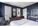 Bedroom features a dark blue wall, a wood sleigh bed, and modern decorations at 4956 Waterside Cir, Carmel, IN 46033