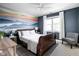 Bedroom featuring a dark wood sleigh bed and mural art on the wall at 4956 Waterside Cir, Carmel, IN 46033