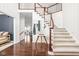 Elegant foyer with hardwood floors, staircase, and stylish decor at 4956 Waterside Cir, Carmel, IN 46033