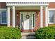 Inviting front entrance with a white door, decorative wreath, and charming landscaping at 4956 Waterside Cir, Carmel, IN 46033